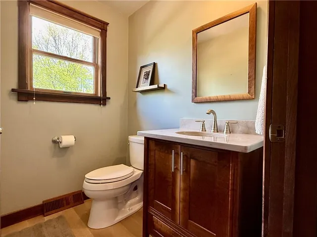 a bathroom with a sink a toilet and mirror