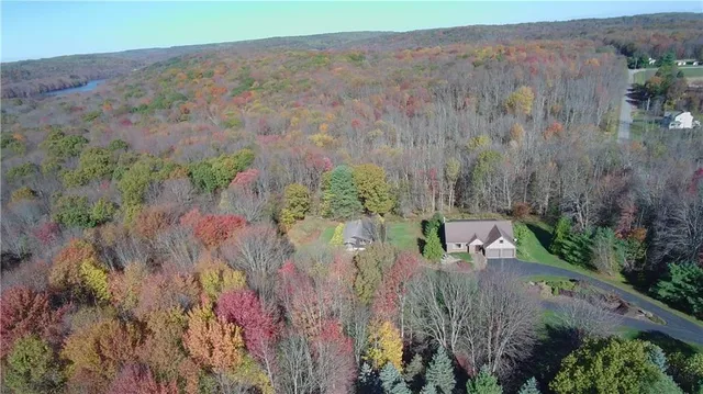 an aerial view of a house with a yard