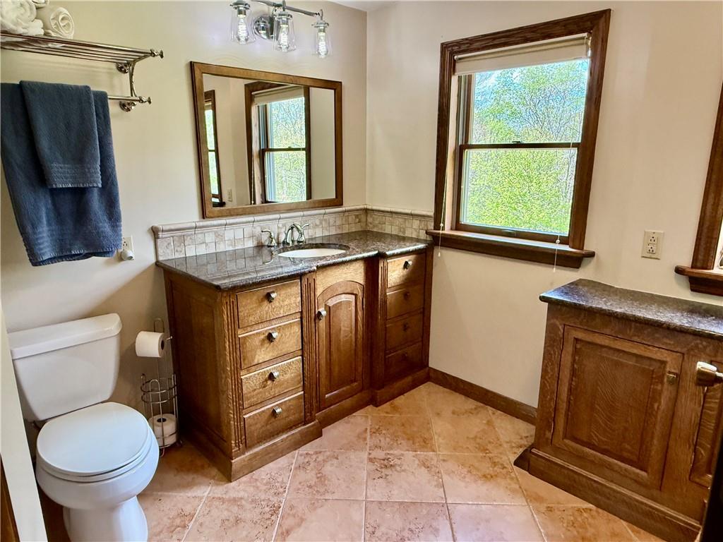 111 McCall Road Butler, PA 16001 - Photo 23 of 50 a bathroom with a granite countertop toilet sink and mirror
