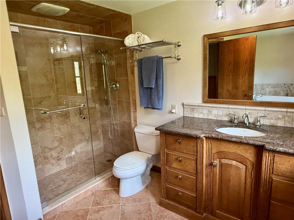 111 McCall Road Butler, PA 16001 - Photo 24 of 50 a bathroom with a granite countertop sink toilet and shower