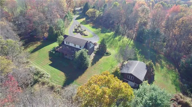 an aerial view of a house with a yard