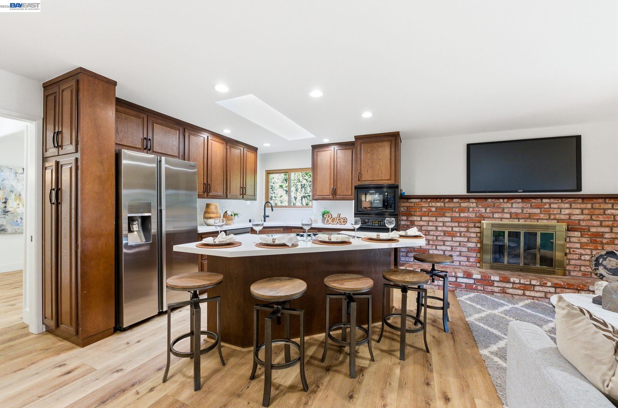 2645 Swanson Way Mountain View, CA 94040 - Photo 27 of 50 a kitchen with kitchen island granite countertop wooden cabinets and a refrigerator