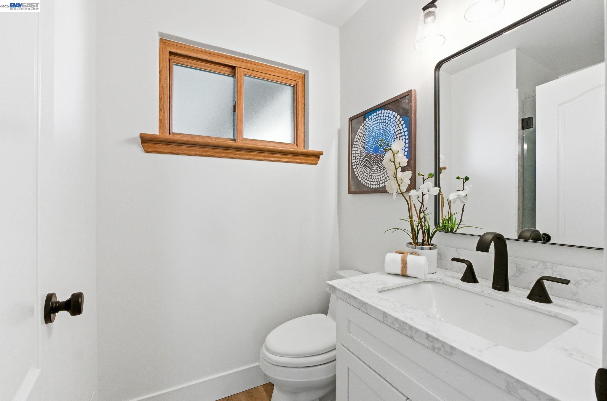 2645 Swanson Way Mountain View, CA 94040 - Photo 39 of 50 a bathroom with a toilet a sink and mirror