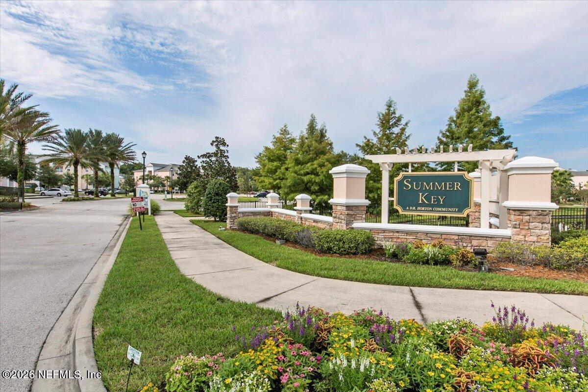 a view of a garden with cars parked