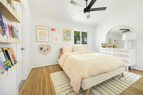 a bedroom with a bed and a painting on the wall