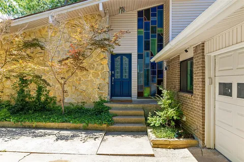 a front view of a house with garden