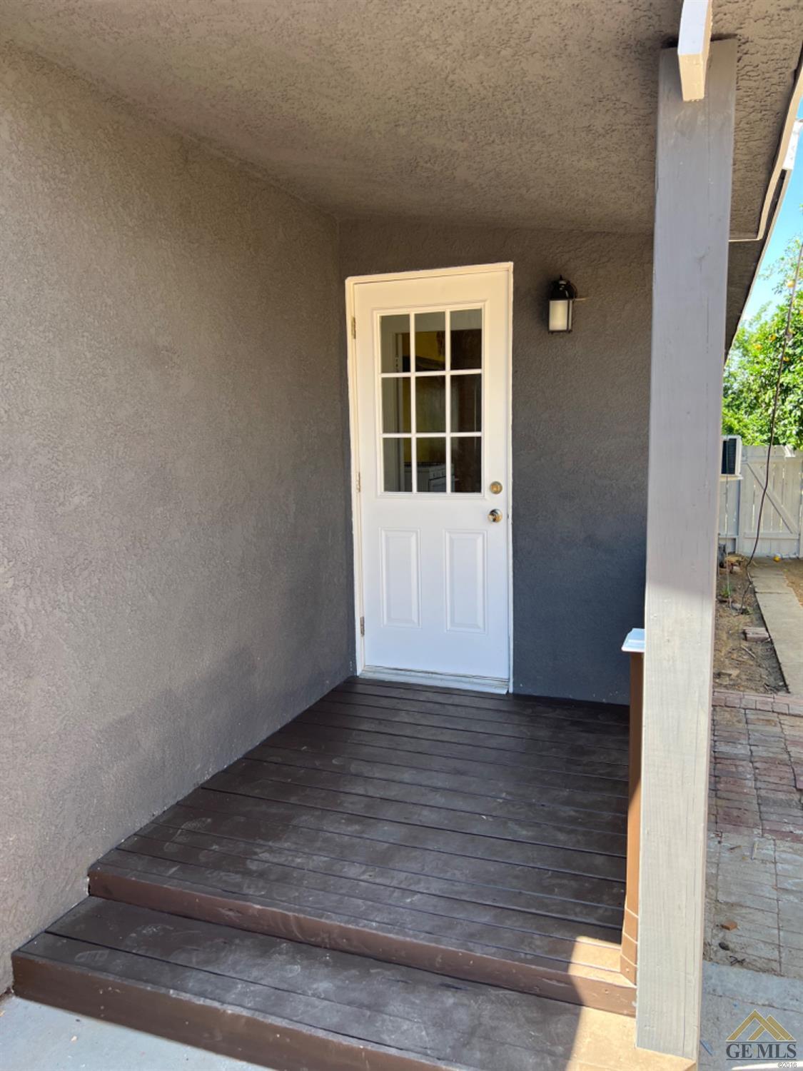 Undisclosed Address Taft, CA 93268 - Photo 14 of 21 a view of an empty room with wooden floor and a window