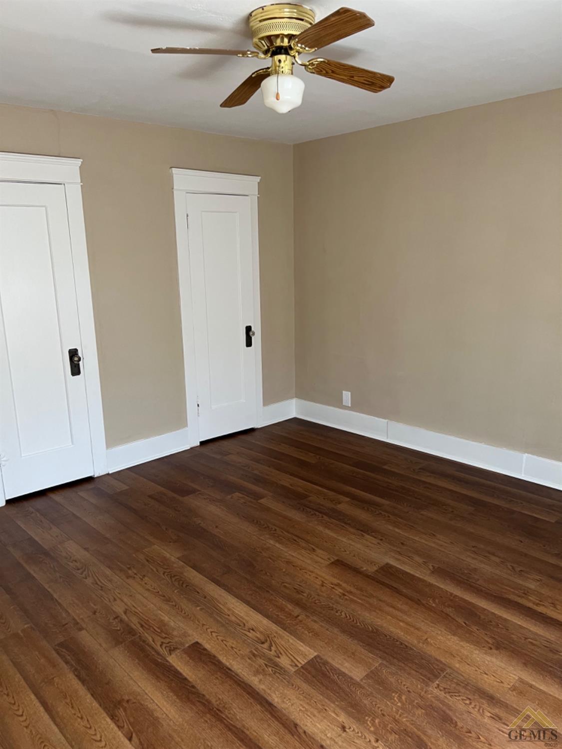 Undisclosed Address Taft, CA 93268 - Photo 9 of 21 a view of an empty room with wooden floor and a ceiling fan