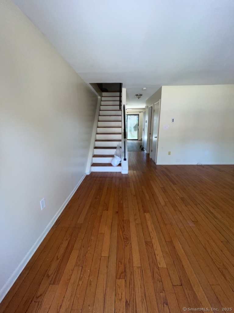 7 Eden Drive, Unit 9 Danbury, CT 06810 - Photo 4 of 9 a view of empty room with wooden floor
