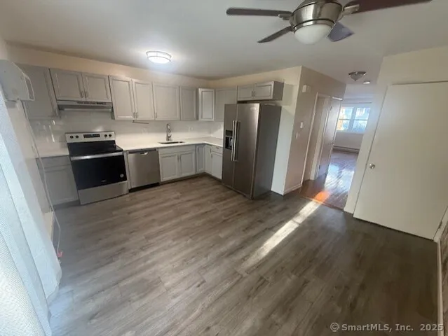 a kitchen with stainless steel appliances a refrigerator and a sink