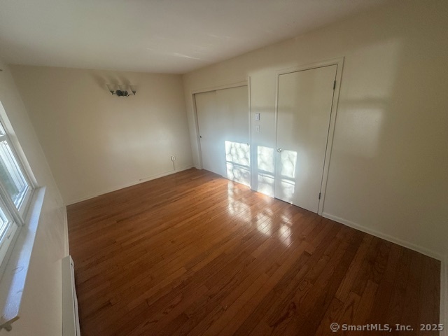 7 Eden Drive, Unit 9 Danbury, CT 06810 - Photo 9 of 9 a view of empty room with wooden floor
