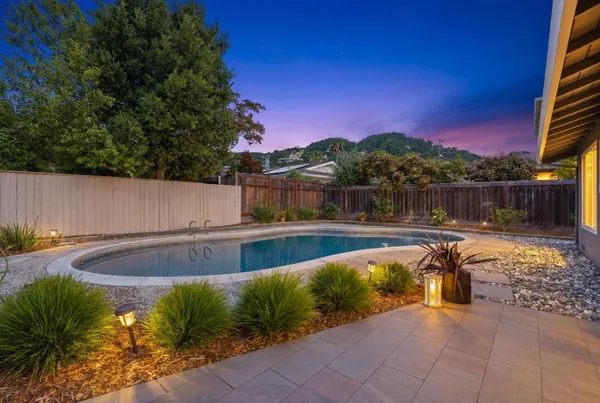 a view of swimming pool with a lounge chair