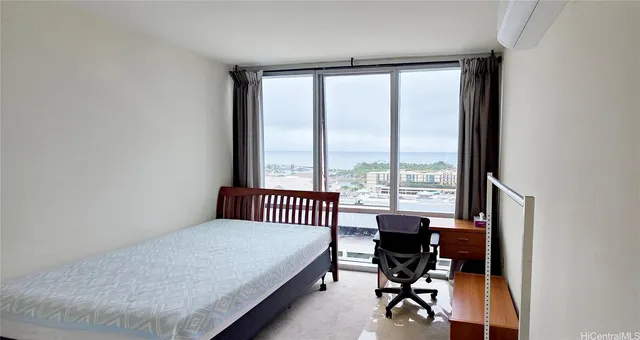 a bedroom with a bed and a desk