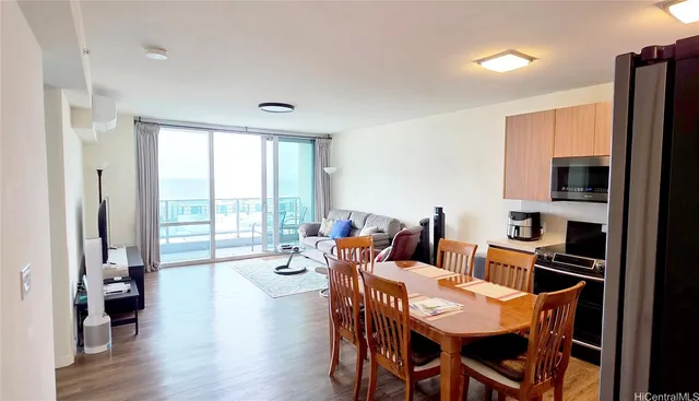 a view of a dining room with furniture window and wooden floor