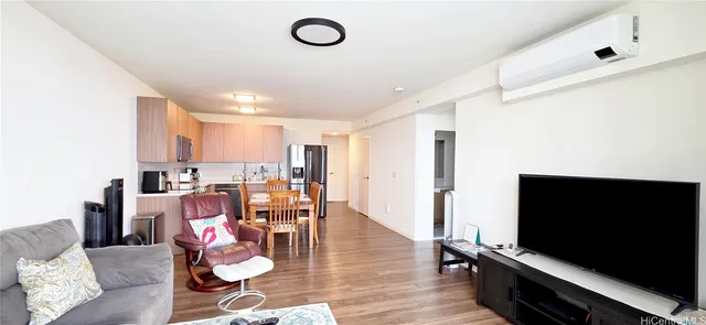 a view of a livingroom with furniture and a flat screen tv