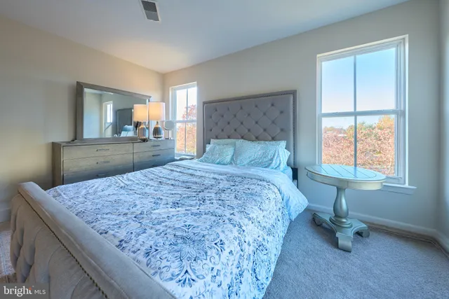 a bed sitting in a bedroom next to a window