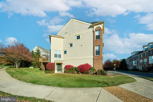 a front view of white house with a yard