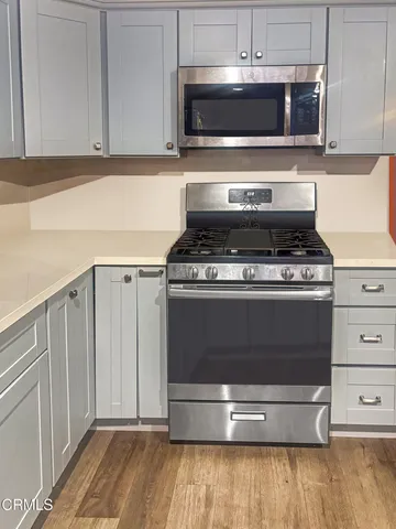 a stove top oven sitting inside of a kitchen