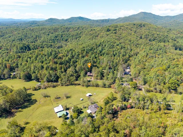 a view of a lake with a bench and trees