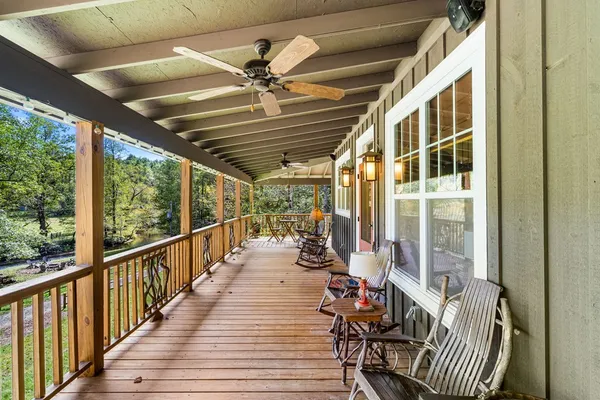 a view of a patio with table and chairs potted plants and large tree