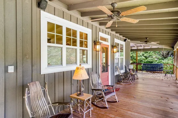 a living room with furniture kitchen view and a large window