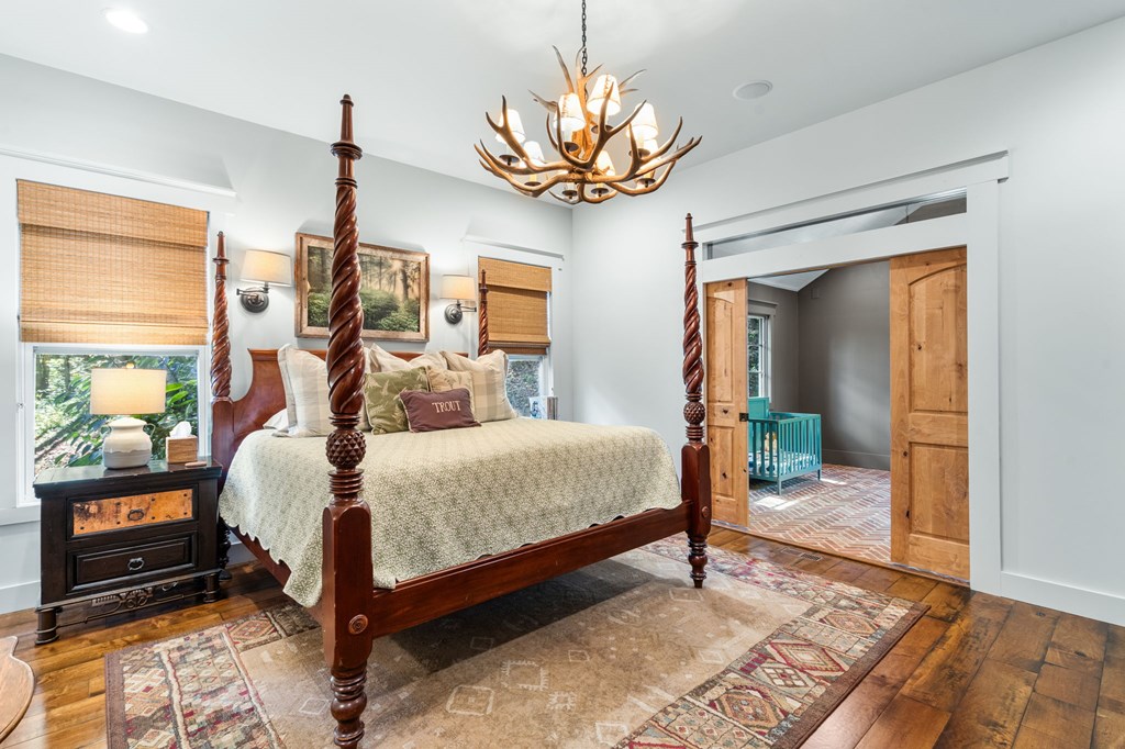 220 Haven Lane Murphy, NC 28906 - Photo 38 of 67 a bedroom with a bed and a chandelier