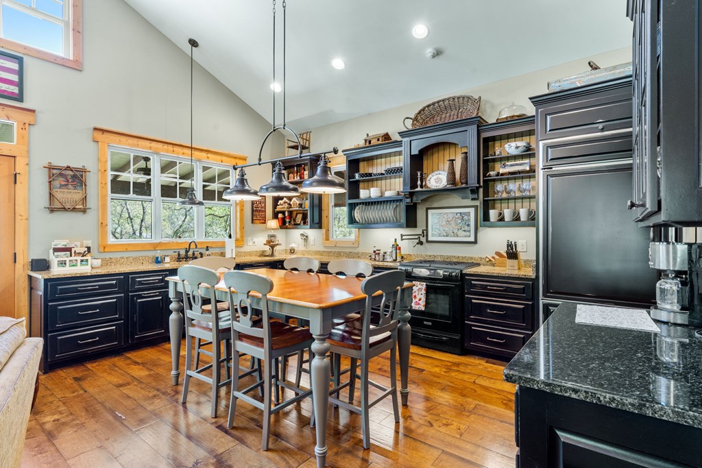 220 Haven Lane Murphy, NC 28906 - Photo 9 of 67 a kitchen with a table chairs and a refrigerator