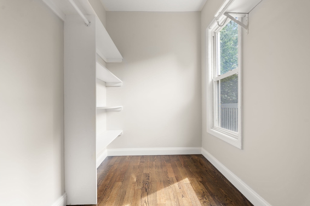 4 Wyoming Street, Unit 2 Boston, MA 02121 - Photo 13 of 23 an empty room with wooden floor and windows