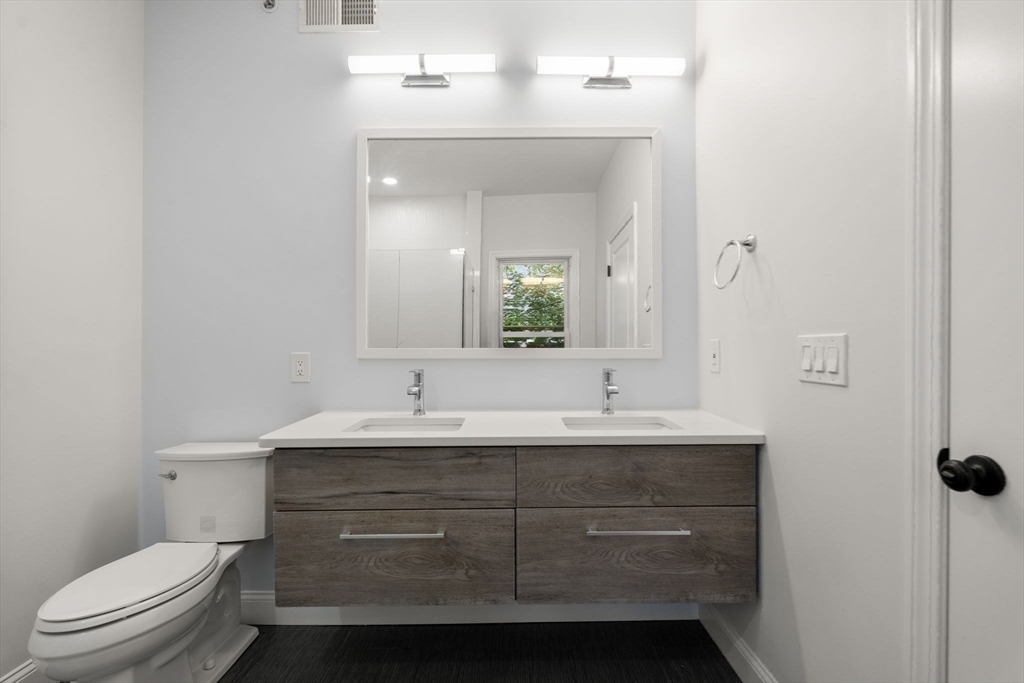 4 Wyoming Street, Unit 2 Boston, MA 02121 - Photo 14 of 23 a bathroom with a sink a toilet a mirror and shower