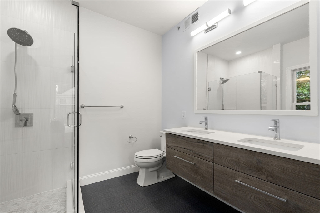 4 Wyoming Street, Unit 2 Boston, MA 02121 - Photo 15 of 23 a bathroom with a toilet sink and mirror