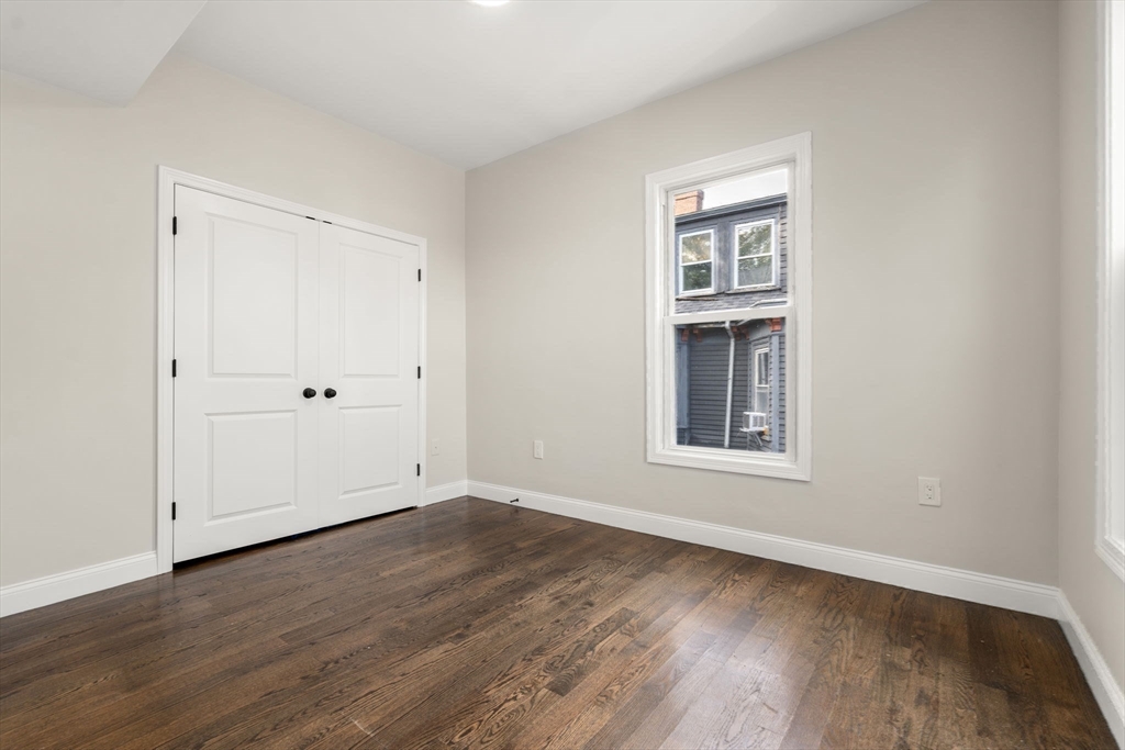 4 Wyoming Street, Unit 2 Boston, MA 02121 - Photo 16 of 23 a view of an empty room with wooden floor