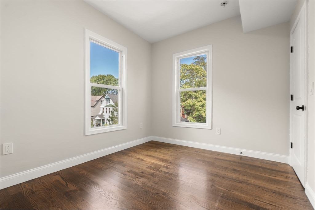 4 Wyoming Street, Unit 2 Boston, MA 02121 - Photo 17 of 23 a view of an empty room with wooden floor and a window