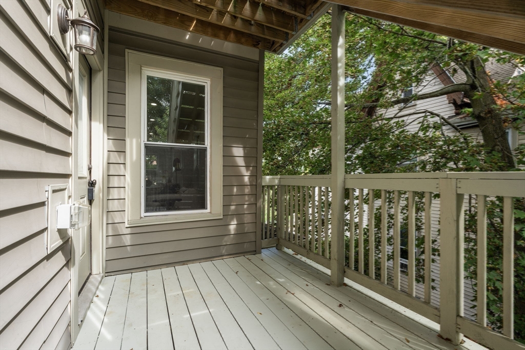4 Wyoming Street, Unit 2 Boston, MA 02121 - Photo 19 of 23 a view of a wooden balcony with a yard