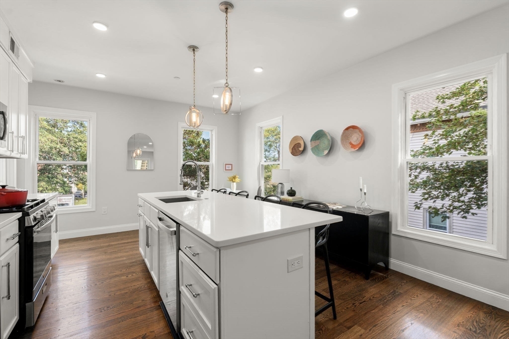 4 Wyoming Street, Unit 2 Boston, MA 02121 - Photo 7 of 23 a kitchen with a sink stove and wooden floor