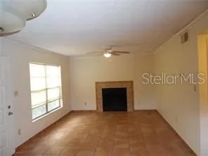 a view of empty room with a fireplace