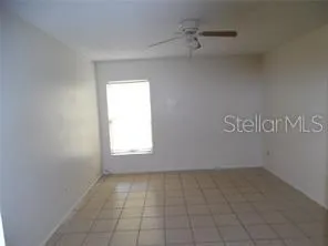 an empty room with white walls and tiles
