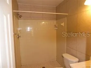 a bathroom with a shower and toilet