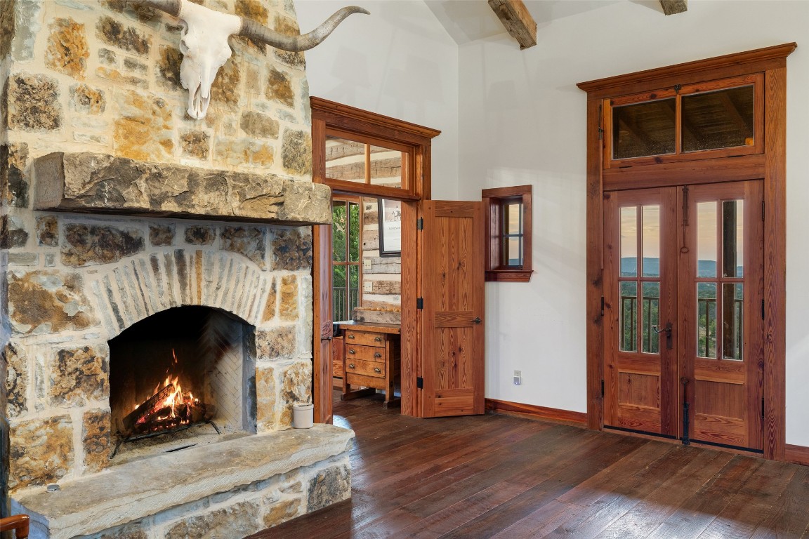 3503 Althaus-Davis Road Fredericksburg, TX 78624 - Photo 22 of 40 a view of an empty room with wooden floor fireplace and windows
