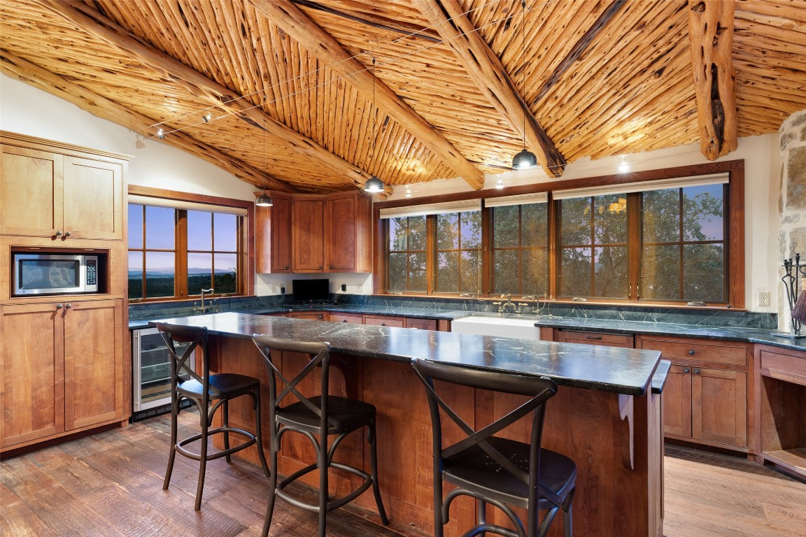 3503 Althaus-Davis Road Fredericksburg, TX 78624 - Photo 8 of 40 a dining hall with stainless steel appliances granite countertop a dining table and chairs with wooden floor