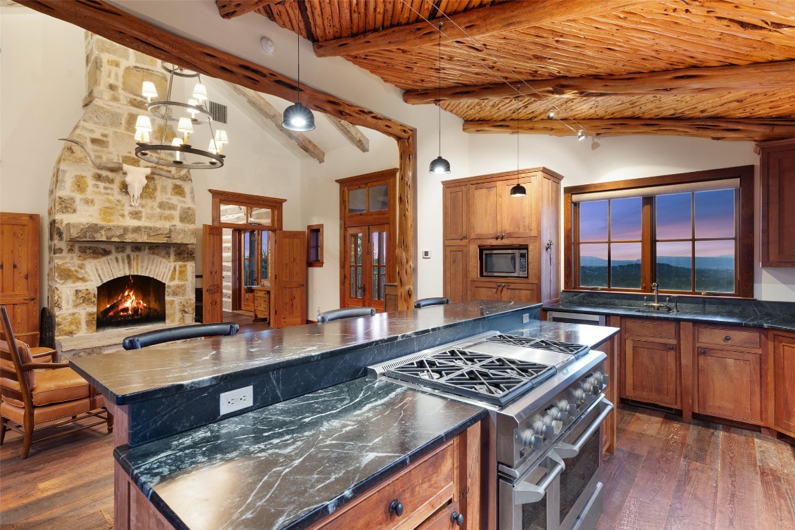 3503 Althaus-Davis Road Fredericksburg, TX 78624 - Photo 9 of 40 a kitchen with stainless steel appliances granite countertop a stove and a wooden cabinets