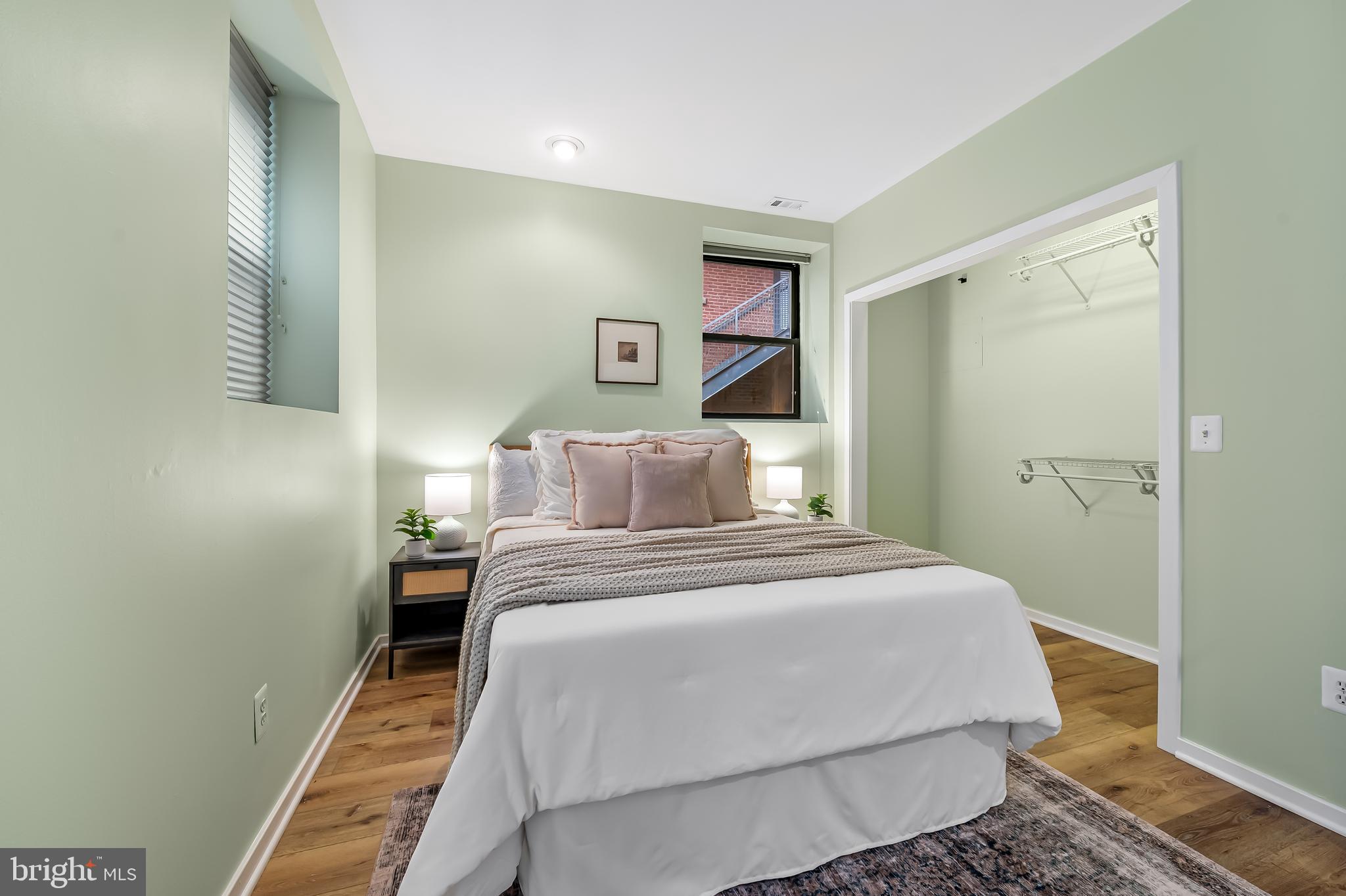 1211 Light Street, Unit 103 Baltimore, MD 21230 - Photo 12 of 31 a bedroom with a bed and a painting on the wall