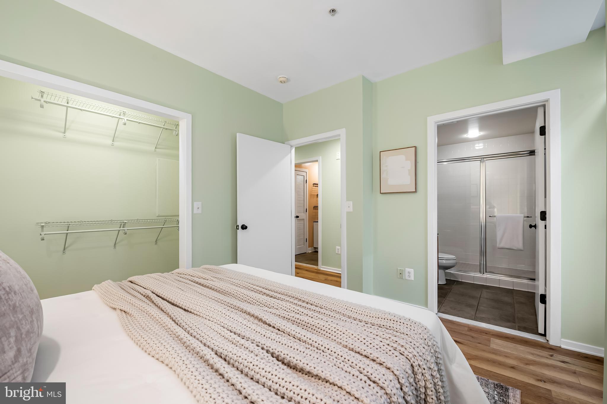 1211 Light Street, Unit 103 Baltimore, MD 21230 - Photo 13 of 31 a bedroom with a bed and a mirror