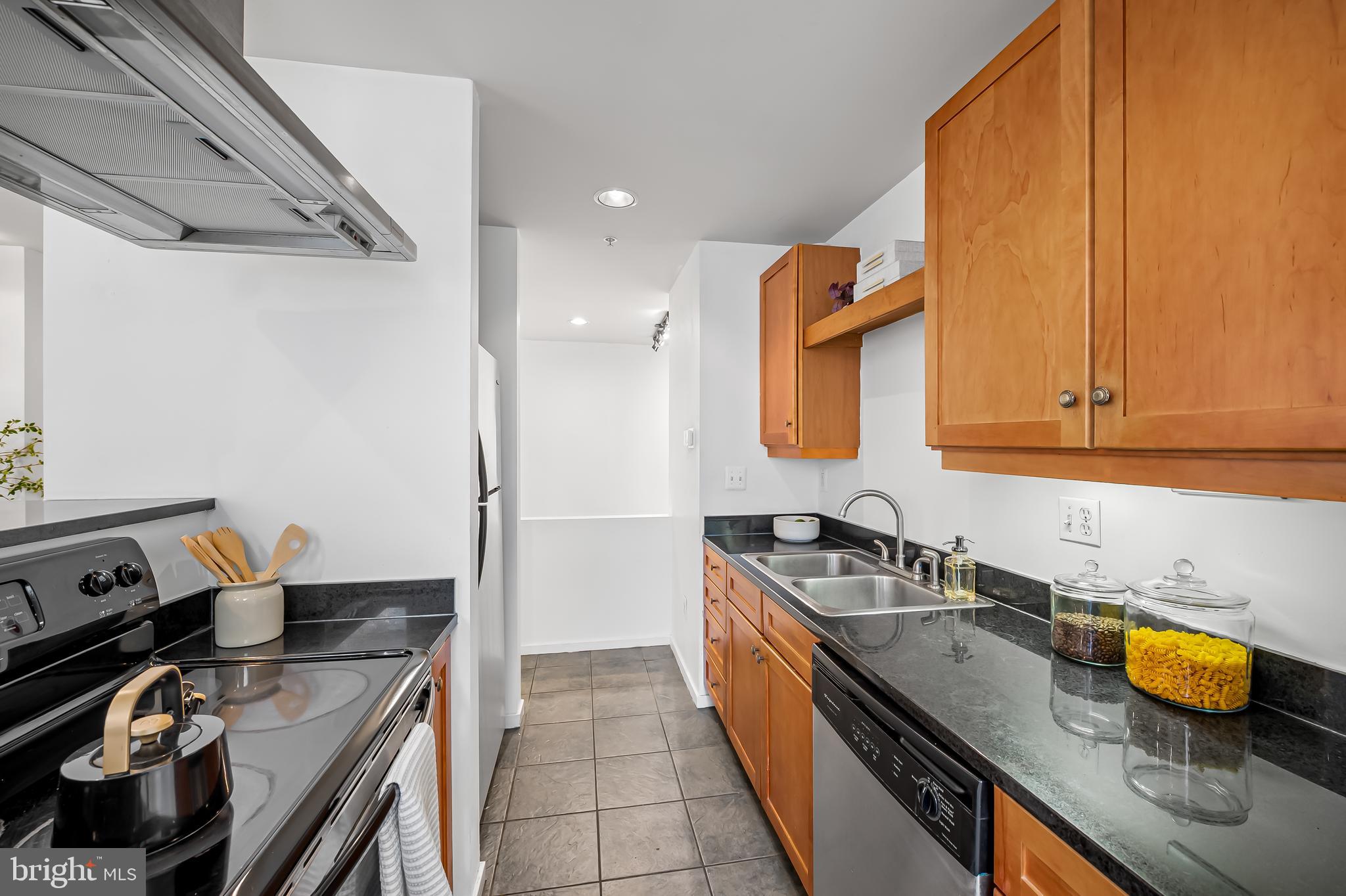 1211 Light Street, Unit 103 Baltimore, MD 21230 - Photo 7 of 31 a kitchen with a sink and a stove top oven