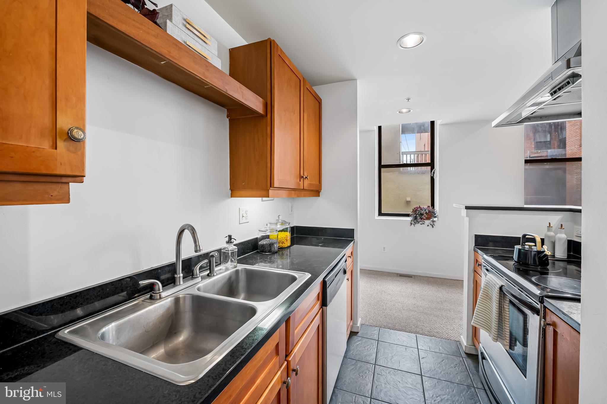 1211 Light Street, Unit 103 Baltimore, MD 21230 - Photo 8 of 31 a kitchen that has a sink and a stove