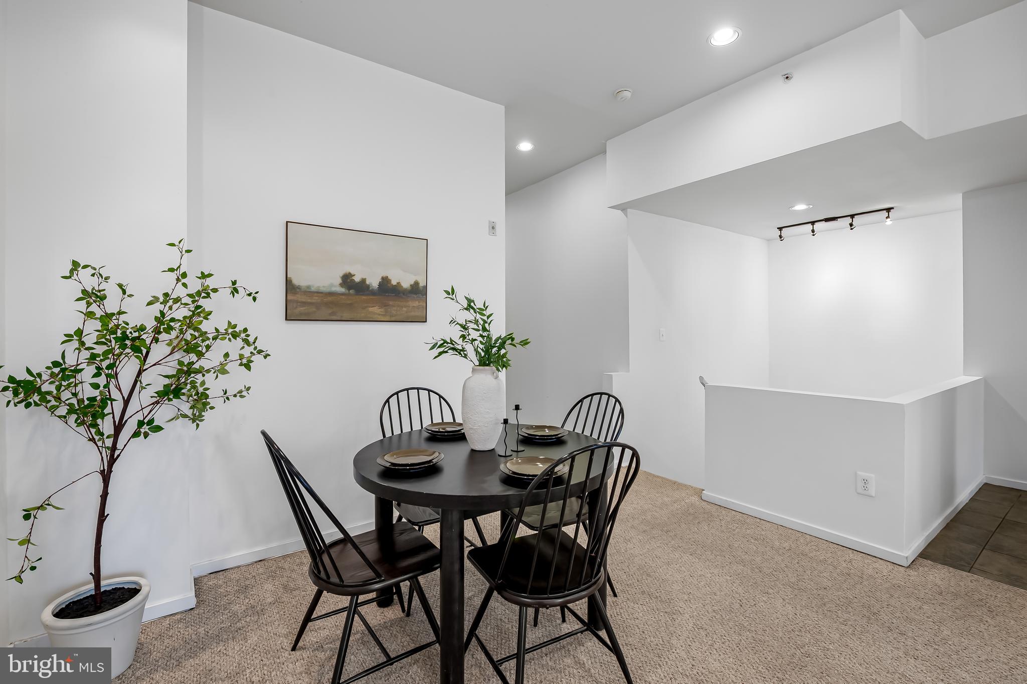 1211 Light Street, Unit 103 Baltimore, MD 21230 - Photo 10 of 31 a view of a dining room with furniture and a potted plant