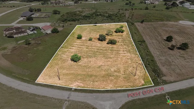 an aerial view of a residential houses with outdoor space