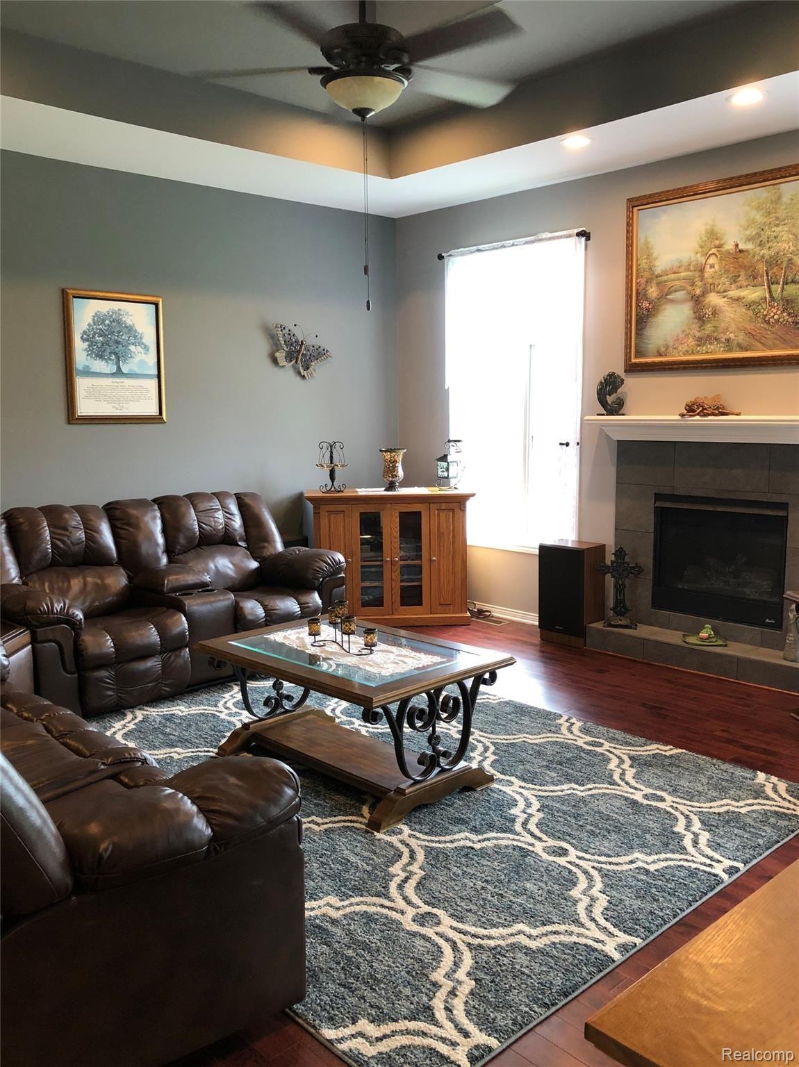 4960 Glover Road Almont, MI 48003 - Photo 15 of 35 Great room with staggered ceiling heights, gas fireplace and ceiling fan