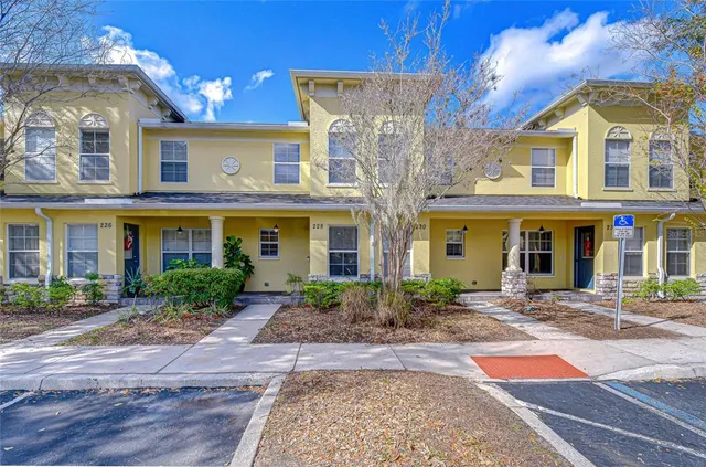 a front view of a brick building with large windows