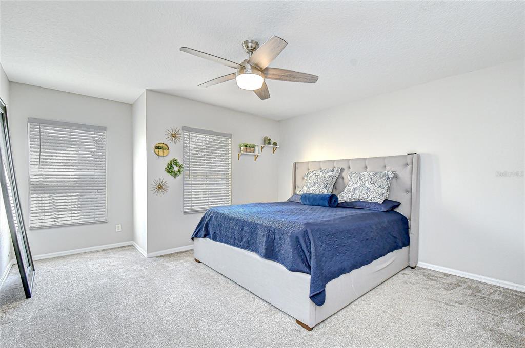 228 Hardcastle Place Valrico, FL 33594 - Photo 11 of 22 a bedroom with a bed and a chandelier