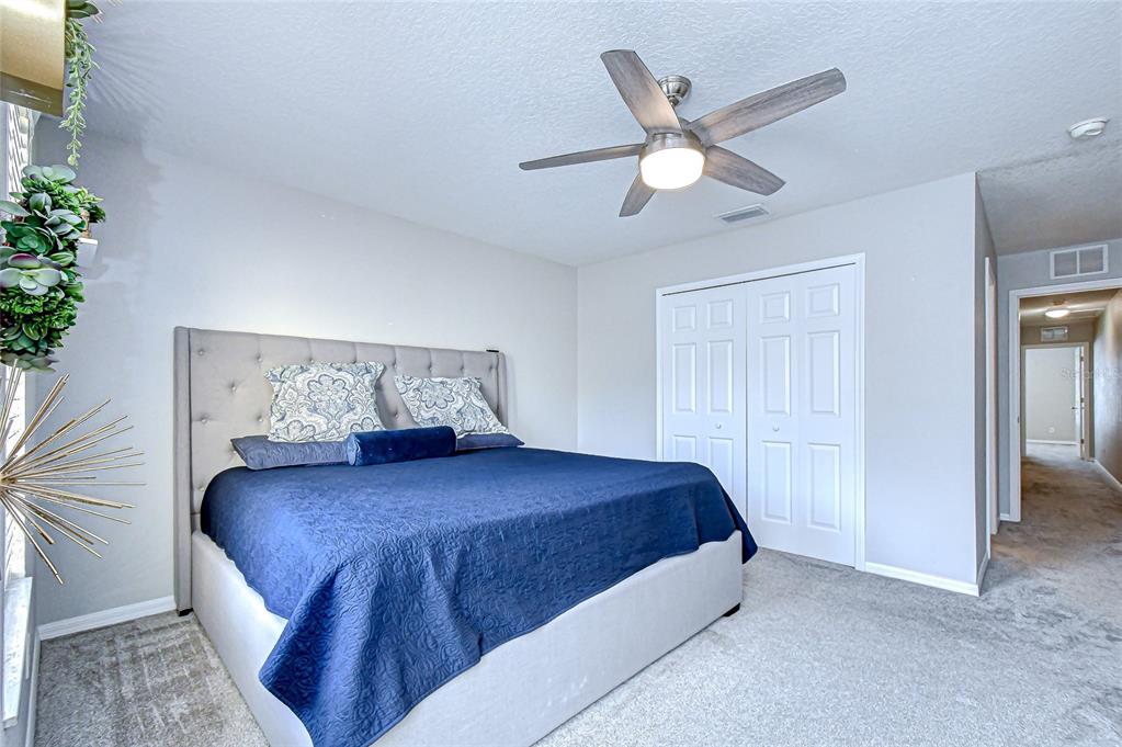 228 Hardcastle Place Valrico, FL 33594 - Photo 12 of 22 a bedroom with a bed and a ceiling fan